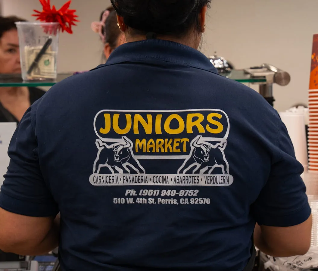 Juniors Market staff uniform with store logo representing team and local grocery service